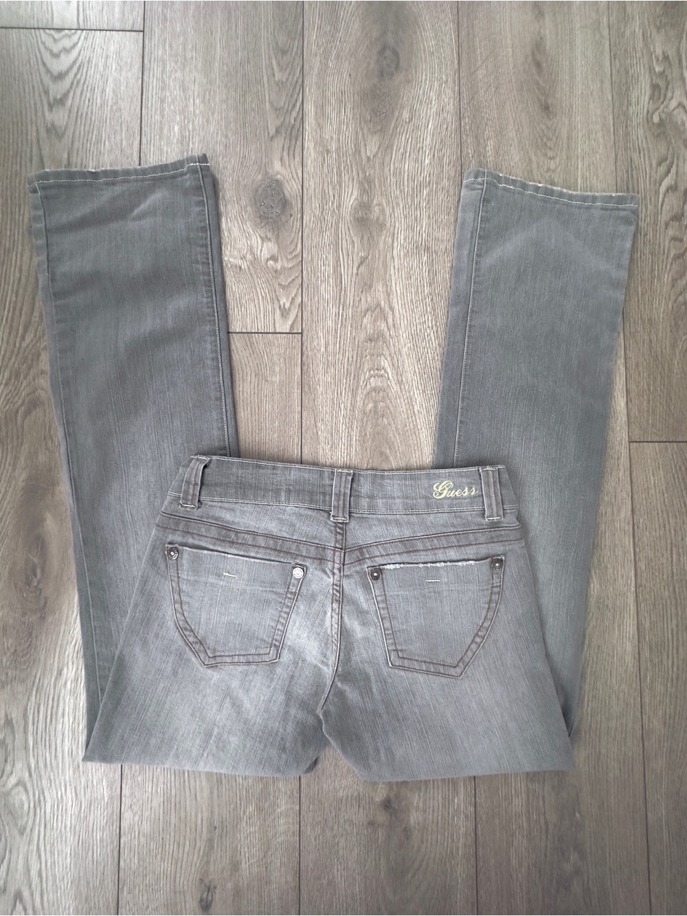 guess grey bootcut jeans with yellow stitching